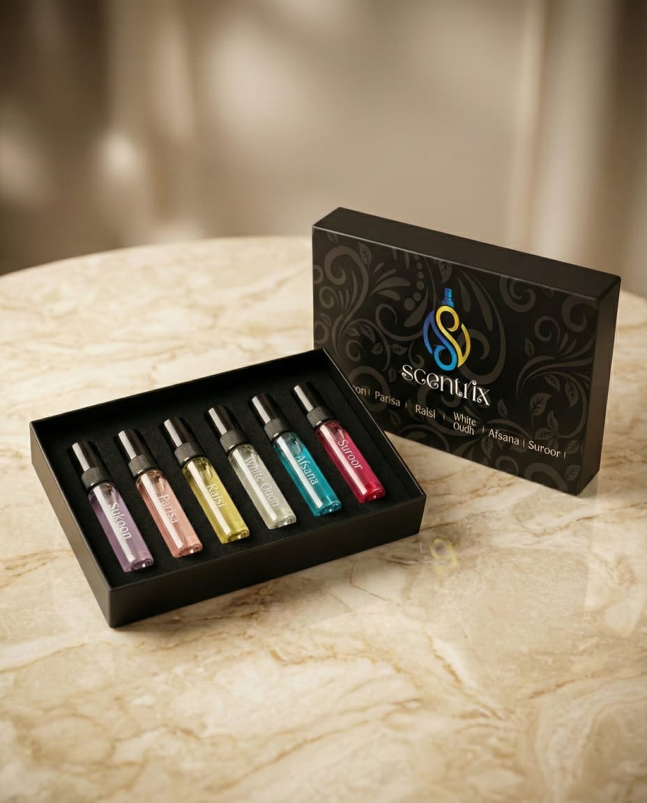 Set of small bottles with colorful liquids in a black box, branded 'Scentix', on a marble surface.